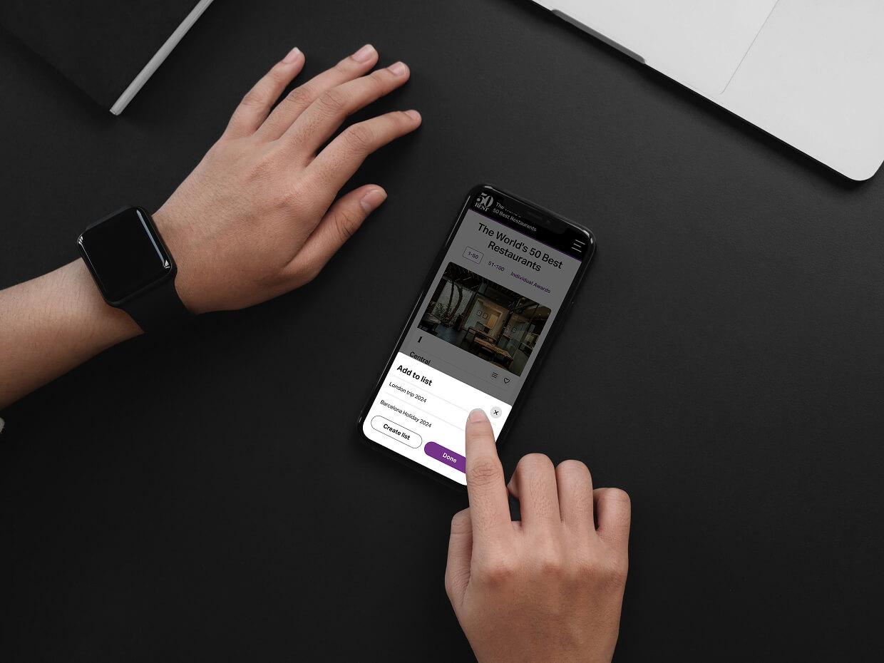 Someone tapping a mobile screen of the Add to List pop-up modal