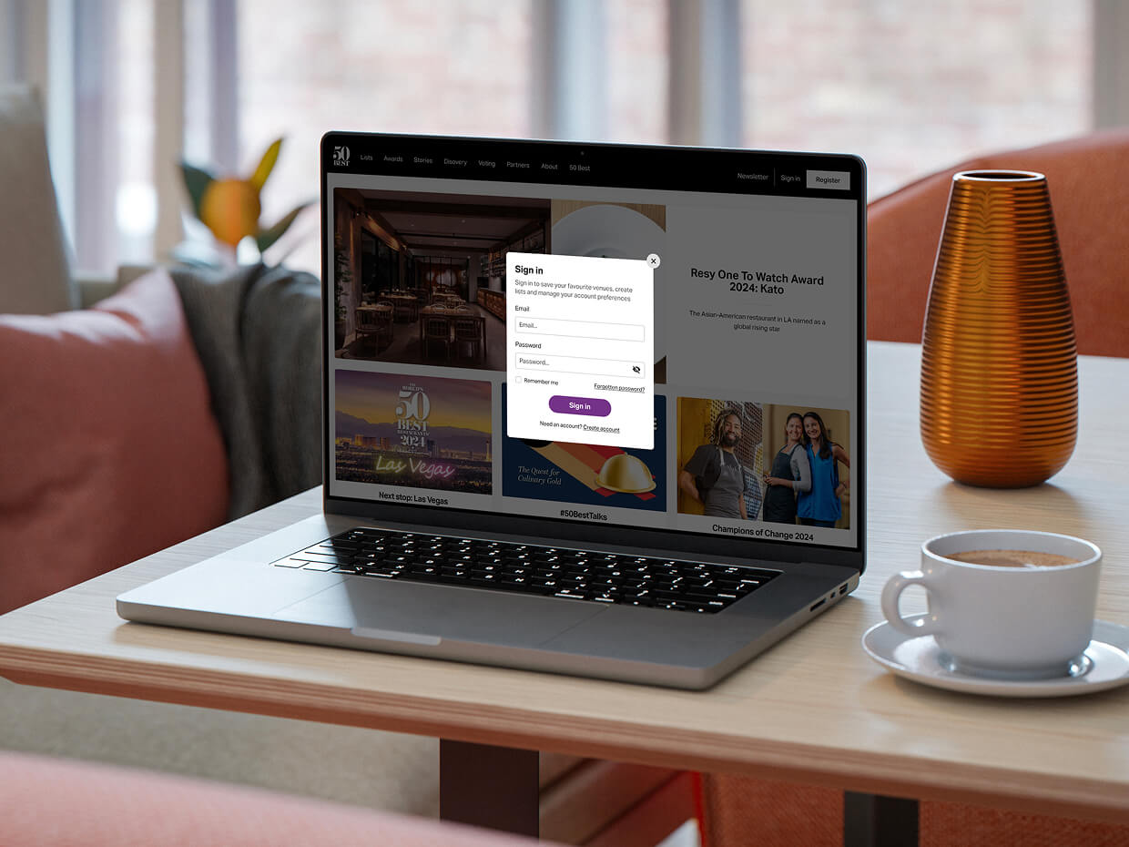An open laptop on a table, featuring the pop-up modal for The World's 50 Best log in